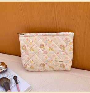 Quilted cute cartoon bear cosmetic bag detail view, soft fabric travel makeup storage pouch.
