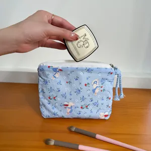 Detail view of cute blue rabbit print coin pouch showing zipper closure and compact storage space.