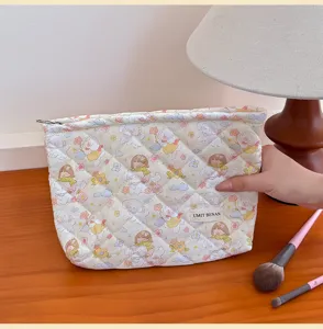 Quilted cosmetic bag with cute cartoon bear pattern, portable zipper makeup pouch for travel.