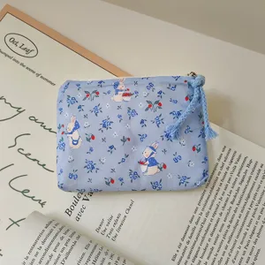Blue floral rabbit coin purse detail showing cute rabbit print fabric and woven zipper pull.