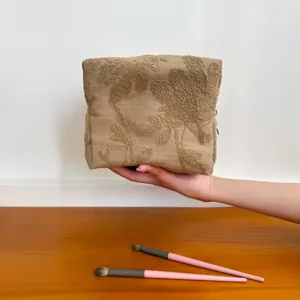 Detailed view of the vintage linen embroidered floral cosmetic bag, portable makeup pouch.