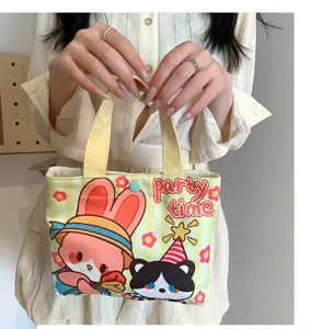 Close-up of a cute canvas handbag with cartoon print, mini tote design and double handles.