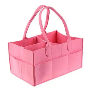 Vue détaillée de l'organisateur de couches en feutre rose avec multiples compartiments.