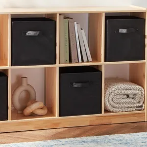 Detailed shot of black collapsible fabric storage cube bin placed in a wooden cube organizer shelf.
