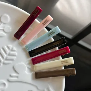 Close-up detail of colorful acrylic hair duckbill clips, elegant side hair clip design.