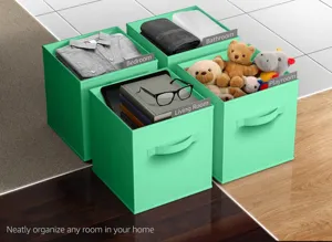 Mint green folding fabric storage box with handle and label holder for neat wardrobe organizer.