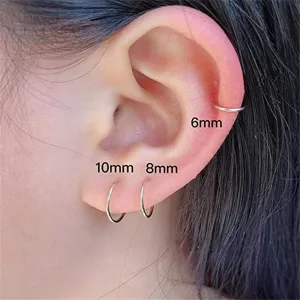 Stainless steel small hoop earrings set, minimalist cartilage piercing rings in various sizes.