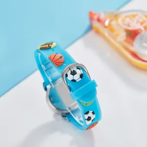 Kids blue silicone quartz watch detail showing cute 3D sports ball strap and secure metal buckle.