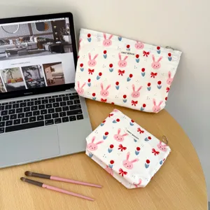 Canvas cosmetic bag with cute pink bunny and tulip print, portable travel makeup storage bag.