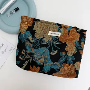 Vintage jacquard cosmetic bag with floral pattern, elegant zipper pouch for travel use.