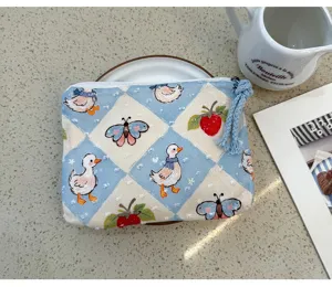 Cute blue checkered cosmetic bag with adorable duck and strawberry print for daily storage.
