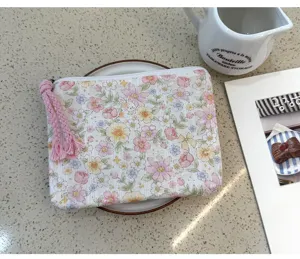 Close-up view of a floral printed cotton storage pouch, ideal for cosmetics and accessories.