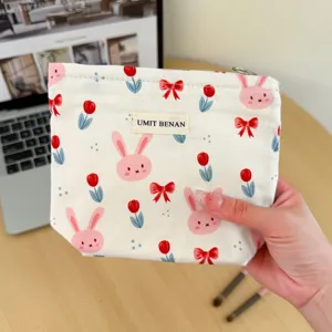 Canvas makeup pouch featuring cute pink rabbit and red tulip print with zipper closure for travel.