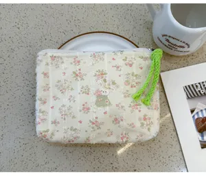 Floral cosmetic pouch with cute bunny print, portable makeup storage bag for daily use.