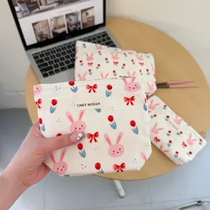 Cute cartoon rabbit makeup bag canvas cosmetic storage pouch with zipper and floral print.