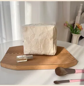 Large capacity embroidered cosmetic bag, beige canvas toiletry pouch for travel, portable makeup organizer.