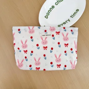 Canvas cosmetic pouch with cute pink rabbit and red tulip print, portable makeup storage bag.
