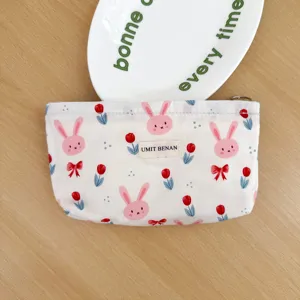 Canvas cosmetic pouch with cute cartoon rabbit and tulip print, portable travel storage bag.