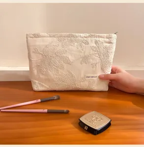Beige embroidered cosmetic bag with floral design, large capacity portable storage bag for travel.