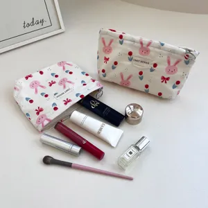 Detail view of cute cartoon rabbit print canvas makeup bag with spacious interior storage.