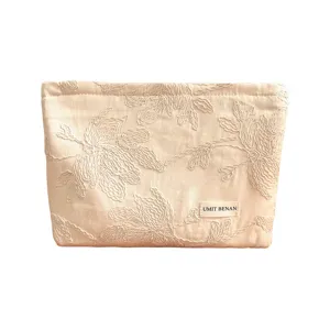 Beige embroidered cosmetic bag, large capacity floral makeup pouch for travel use.