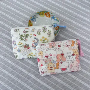 Close-up view of cute cartoon canvas zipper pouch with adorable animal prints for daily storage.