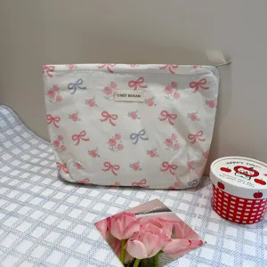 Cute bow print cosmetic bag, large capacity portable makeup pouch for travel and daily storage.