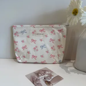 Detailed view of cosmetic bag with bow and floral pattern, elegant design for daily use.