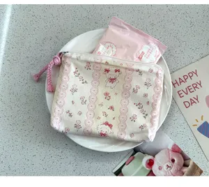 Cute floral canvas coin purse detail shot, showing portable mini storage bag for essentials.