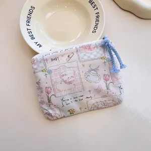 Close-up detail shot of a cute cartoon printed canvas zipper coin pouch with blue braided pull.