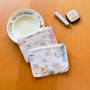 Detail close-up of cute cartoon canvas cosmetic bag, multi-functional portable travel storage pouch.