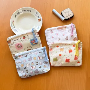 Cute cartoon canvas coin purse portable cosmetic storage bag detail view and multi-color design.