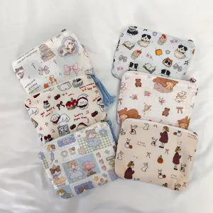 Cute mini canvas coin purse and cosmetic storage bag with adorable printed patterns for women.