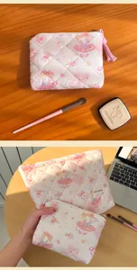 Cute quilted makeup bag with sweet cartoon girl print, portable pink cosmetic pouch for travel.