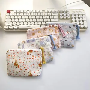 Cute mini coin purse makeup pouch set with zipper and braided pull, portable storage bag.