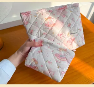 Quilted pink cosmetic pouch set with cute cartoon girl print, large capacity travel storage bag for daily use.
