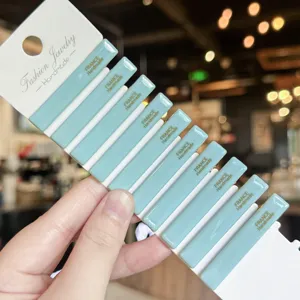 Light blue acrylic side hair clip detail shot, elegant gold stamped lettering design.