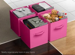 Pink foldable storage bins with handles and label holders, perfect for organizing home items.