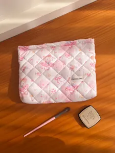 Cute pink quilted cartoon makeup bag with zip closure, perfect for daily travel and storage.