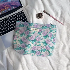 Detailed view of the floral cotton cosmetic pouch showcasing vintage purple flower pattern.