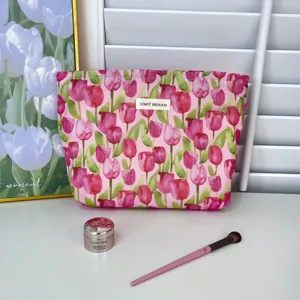 Floral print cotton makeup bag with zip closure, stylish cosmetic pouch for travel.