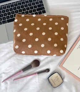 Brown corduroy polka dot makeup bag detail showing soft textured fabric and vintage style.