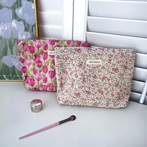 Floral cosmetic bag detail showing soft cotton fabric, cute tulip print, and secure zipper closure.