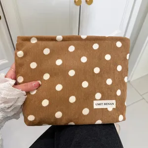 Brown corduroy cosmetic bag with white polka dots retro travel makeup pouch for women.