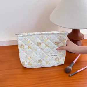 Quilted makeup bag with cute cartoon bear design, portable large capacity travel pouch.
