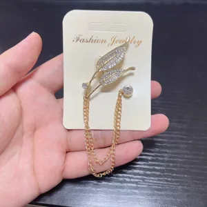 Elegant gold leaf rhinestone brooch with double chain tassels for suit lapel anti-glare pin.