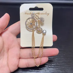 Elegant rhinestone bicycle brooch with tassel chain, vintage suit lapel pin for women.