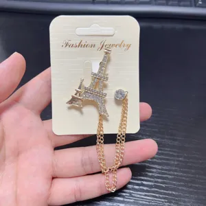 Gold Eiffel Tower rhinestone brooch with chain tassel, elegant suit lapel pin for women