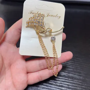 Elegant rhinestone tassel brooch, gold metal bird design suit pin for women detail view.