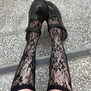 Black floral lace Lolita stockings for women, sweet JK cute knee-high socks with platform shoes.